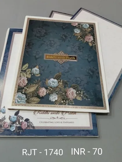 A beautiful floral invitation in a deep teal color. The design is rich and elegant, with matching inserts that continue the floral theme.