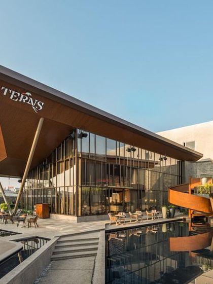 The bold, angular roof planes of 'Terns' create a dramatic architectural form that defines the restobar's identity.