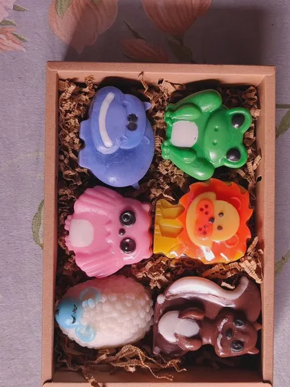 The animal soaps unboxed, showing the variety of creatures like a sheep, skunk, lion, and frog.