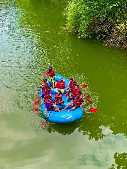 An aerial view of a kids' rafting team at Shivpura, showing their progress as they navigate the calm waters.