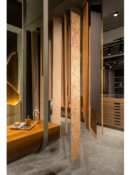 A detail shot of the hanging veneer samples, showcasing a variety of textures and finishes, from smooth wood grain to rough particle board.