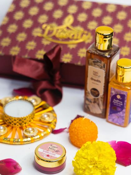 This premium Diwali hamper is perfect for indulgent gifting. It contains Oudh and Saffron Facewash, a Bubblegum lip balm, and ladoo-shaped candles, all presented in a luxurious gift box.