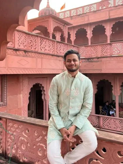 A client wearing a pista green kurta with a matching embroidered jacket. This is a versatile outfit that can be worn for a variety of festive occasions.