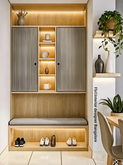 An elegant and practical entryway solution designed to keep your home tidy. This unit features fluted cabinet doors, open shelving with accent lighting, a comfortable seating bench, and dedicated shoe storage underneath, making a great first impression.