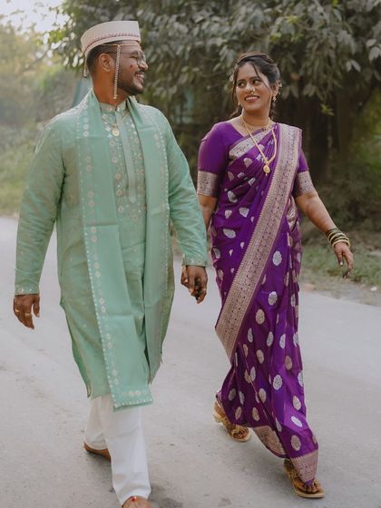 The couple walking together during their Punyahwachan. The look is traditional yet comfortable for moving around during the ceremony.
