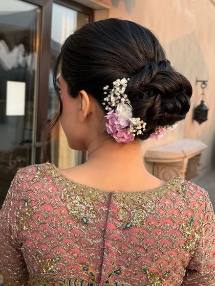 The full back view of the textured bun, perfect for a bride who wants a romantic and detailed hairstyle.