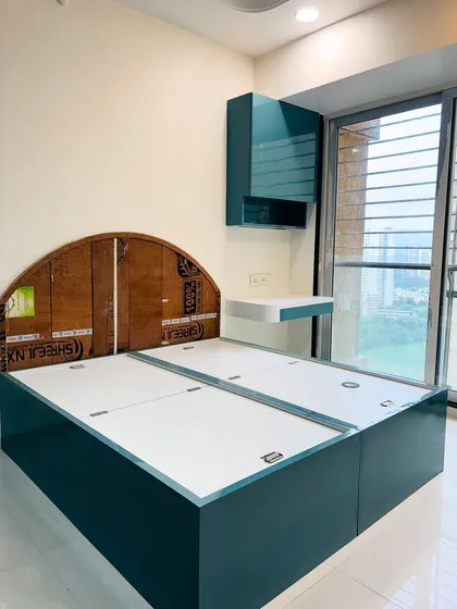 This image shows the bed frame and headboard structure before the mattress is added. It reveals the hydraulic lift mechanism for easy access to the large under-bed storage compartments.