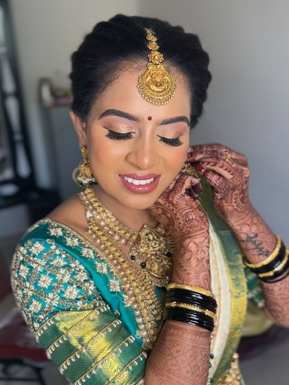 An eyes-closed shot to highlight the soft, blended eyeshadow and the intricate details of her henna.