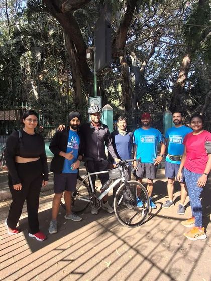 A group photo with a fellow runner on his bicycle. Our community is welcoming to everyone, whether you are running, walking, or cycling. We all share the same love for being active outdoors.