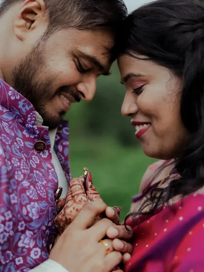 An intimate close-up of Milind and Anushree after their engagement. The focus is on their happy expressions and the bride's beautiful mehendi.
