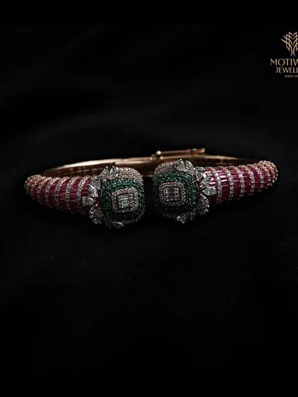 A bold and colourful cuff bracelet with ruby and emerald elements, showcasing our mastery of gemstone combinations.