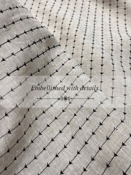 This fabric with black arrow-like embroidery offers a modern and graphic option for a unique garment.
