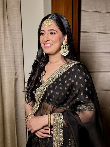 Soft curls, champagne shimmers, and a glow that lasts all evening. This gorgeous bridesmaid in black is the picture of girly, graceful glam.