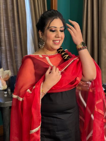 A candid shot showing the client's complete look. The makeup and hair are perfectly styled for a festive and elegant appearance.