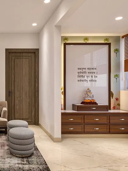 A semi-open pooja space integrated into the living area, featuring a custom wooden cabinet and a glass panel inscribed with a Sanskrit shloka.