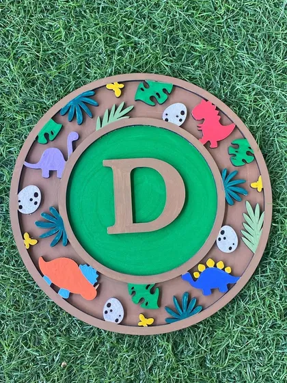 This dinosaur-themed monogram is dino-mite! It's a fantastic project for any kid who loves T-Rex and friends, combining painting with assembling fun 3D elements.