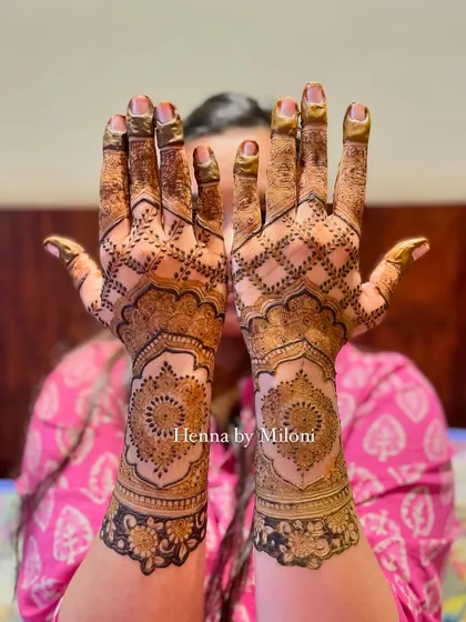 A full-coverage design with a central mandala and intricate grid work on the arms.