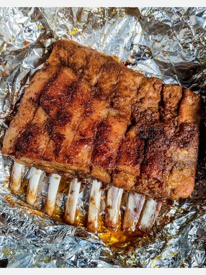 A rack of my Grilled Pork Spare Ribs, marinated overnight in a homemade spice rub and slow-grilled for six hours. The result is incredibly tender meat that just falls off the bone.