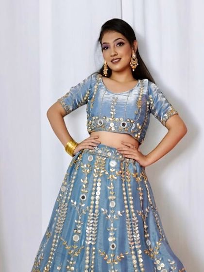 A full view of the modern party look. Notice how the makeup complements the mirror work on the lehenga. We focus on creating a cohesive style from head to toe.