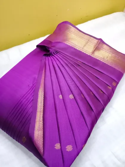 A regal purple silk saree with a gold border, now perfectly pleated. My service is available in both Jayanagar and Mathikere for your convenience.