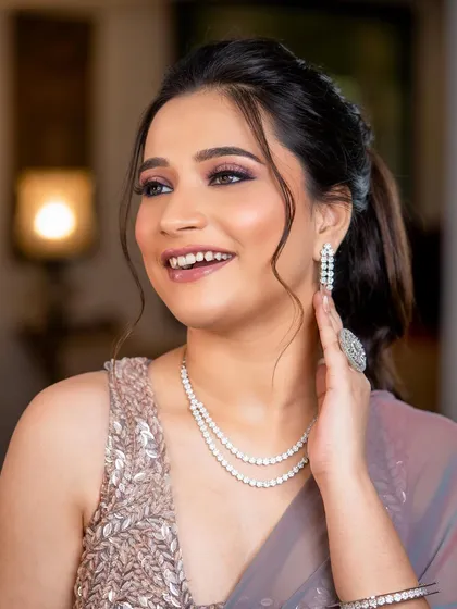 A happy, smiling client ready for her sangeet. This look proves that you can have dramatic, glittery makeup that still feels fresh and joyful.