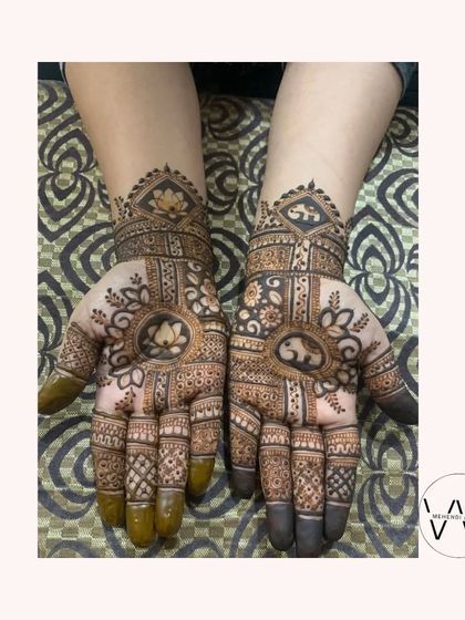 A designer mehndi with a mix of lotus and elephant motifs.