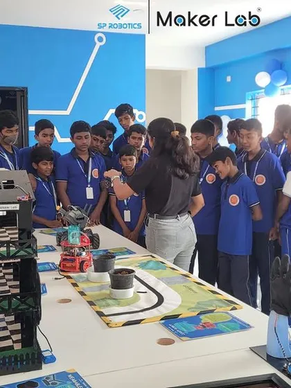 An instructor demonstrates a complex robot to a group of visiting students. We break down advanced concepts to make them understandable and exciting for all ages.