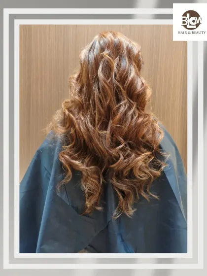 Rich, coppery tones styled into loose, messy curls. This look is effortlessly glamorous and full of warmth.