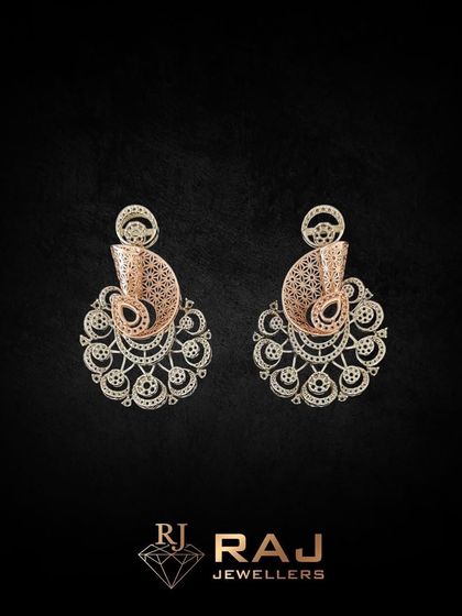 An ornate earring set featuring a paisley motif with intricate filigree work. These chaandbali-style earrings are crafted to be lightweight yet visually impactful, perfect for festive occasions.