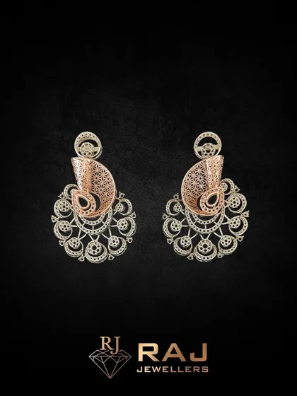 An ornate earring set featuring a paisley motif with intricate filigree work. These chaandbali-style earrings are crafted to be lightweight yet visually impactful, perfect for festive occasions.