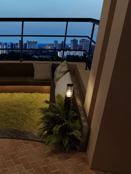 The interplay of light and shadow at dusk creates a serene and contemplative mood on the terrace.