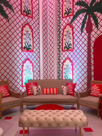 Another view of the lounge area, showcasing the lattice-patterned walls and the beautiful floral artwork within the arched niches. The design creates a space that is both grand and inviting.