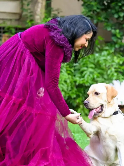 A girl's best friend. This tender moment between the mom-to-be and her loyal dog shows that the whole family, paws and all, is part of this journey.