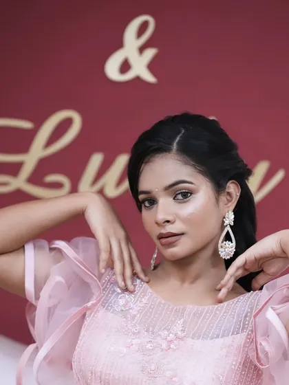 A full-on look at the camera, showcasing the beautiful, sparkling earrings and the makeup that complements them perfectly.