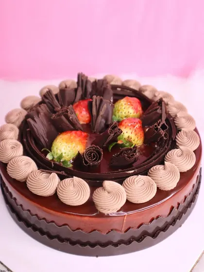 Our Chocolate Strawberry Cake is the ultimate romance of flavors. Rich chocolate cake is topped with fresh strawberries and chocolate shavings.