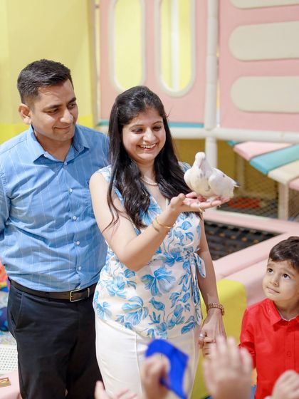 A mother's joyful reaction to a magic trick involving a live dove. Our magic shows are designed to entertain the entire family, creating shared moments of amazement.
