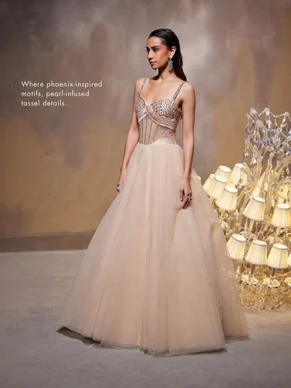 The Bella Gown, where phoenix-inspired motifs and pearl-infused tassel details adorn the exquisite corset, blending artistry with a breathtaking silhouette.