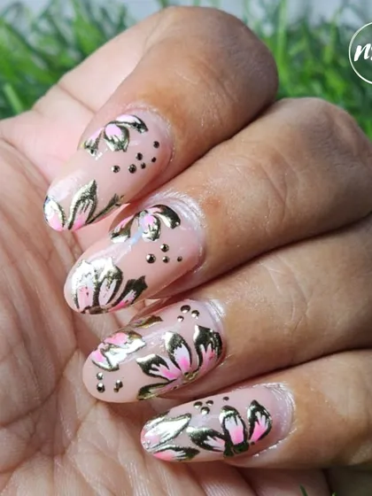 Another angle of this stunning floral and gold foil nail art by a student, showing the consistency and detail in their work.