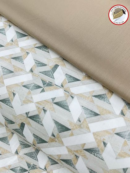This geometric print fabric is shown with a matching plain fabric for the izaar. This combination creates a coordinated and stylish kurta izaar set.