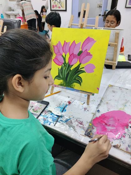 Watch the step-by-step process as a student paints a bright and cheerful bouquet of tulips on a yellow background.
