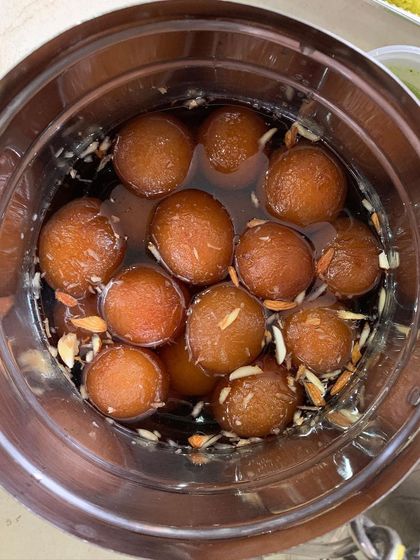 A comforting bowl of homemade Gulab Jamuns, soaked in sweet syrup and garnished with almonds. A classic Indian dessert that I love to prepare for special occasions.