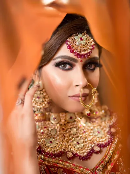 A dramatic and artistic shot of a bride. The focus is on her intense, smokey eyes, which create a captivating and memorable look.