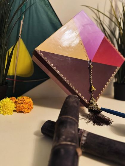 A dramatic shot of the kite-themed hamper box, highlighting its unique shape and festive tassel.