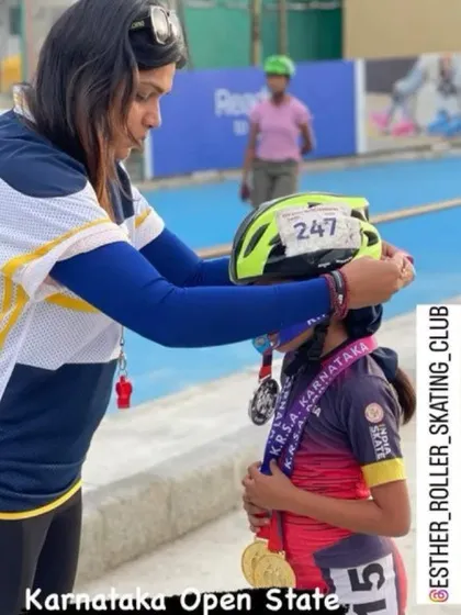 Adjusting a young skater's helmet after her win at the Karnataka Open State championship. These small moments of connection are just as important as the medals.