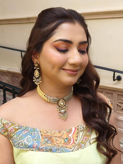 Eyes closed to showcase the blend of colors on the eyelid. This is a great way to incorporate your outfit's colors into your makeup.