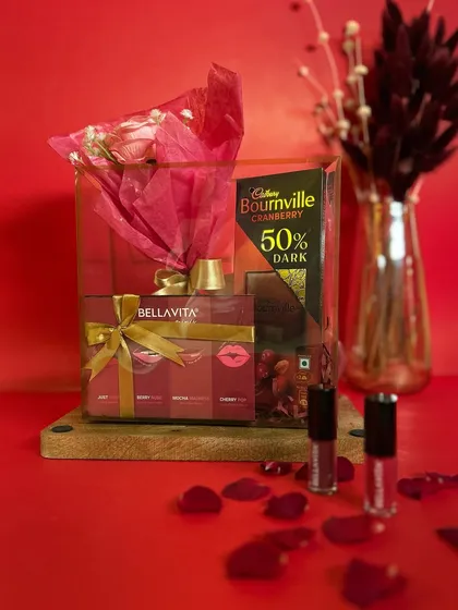 The 'Elegant Bloom' hamper is all about classic romance. It includes a forever rose, a set of Bella Vita lipsticks, and cranberry dark chocolate, beautifully arranged for a lasting impression.
