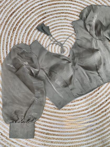 A ready-to-wear pure soft organza blouse in a subtle grey with dramatic balloon sleeves.