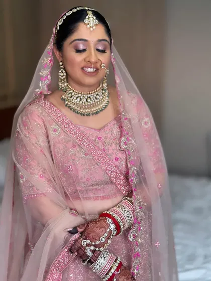 My bride Nilomi, looking pretty in pink. This shot captures her full look with the dupatta, showing how the soft makeup complements the delicate embroidery of her outfit.