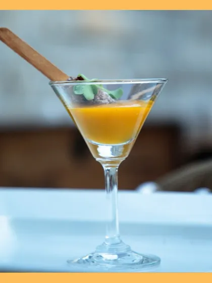 An elegant presentation of our Thai fritters with mango coulis, served in a martini glass for a touch of sophistication.