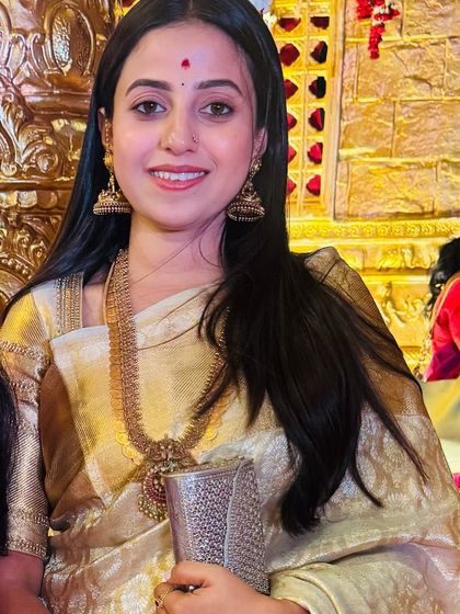 A close-up of Soundarya, her happy expression and the shimmering saree making for a perfect picture.